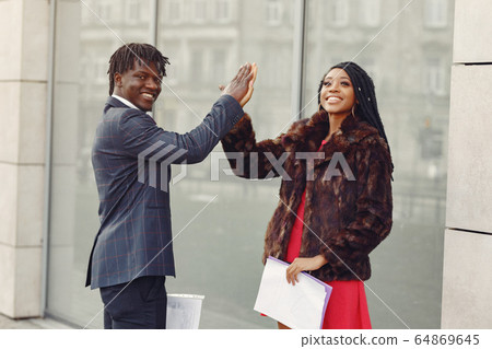 Stylish black couple have business conversation 64869645