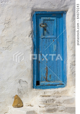 Close shot of blue door on a white house in 64870143