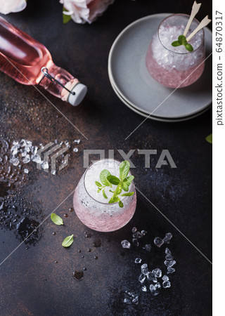Pink cocktail with mint 64870317