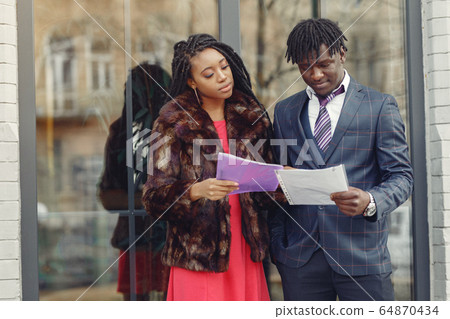 Stylish black couple have business conversation Stylish black couple have business conversation 64870434