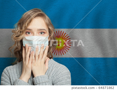 Shocked woman in medical mask on Argentinian flag 64871862