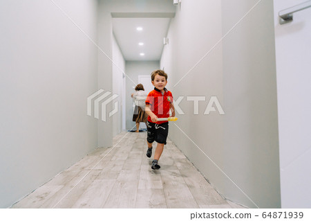 the boy runs down the hall of the house the boy runs down the hall of the house 64871939