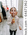 Child playing with soap bubbles in the home 64871962