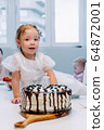 Portrait of cute little girl celebrating third birthday. 64872001