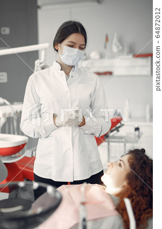 Beautiful girl sitting in the dentist's office Beautiful girl sitting in the dentist's office 64872012