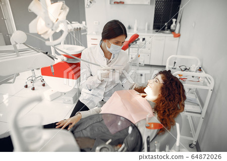 Beautiful girl sitting in the dentist's office 64872026