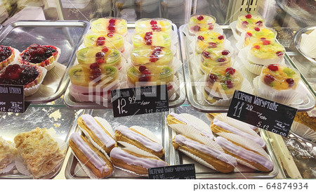 Cupcakes of different types on a shop window. Cupcakes of different types on a shop window. 64874934