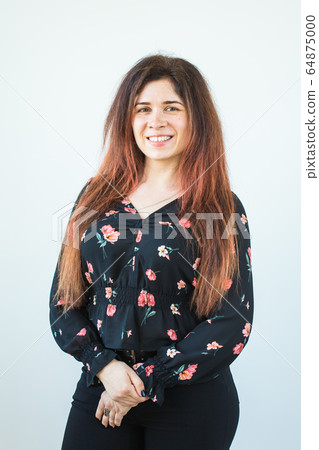 Close up portrait of funny attractive pretty girl with long ginger fair hair standing on white background. Close up portrait of funny attractive pretty girl with long ginger fair hair standing on white background. 64875000