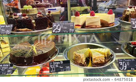 Cupcakes of different types on a shop window. 64875018