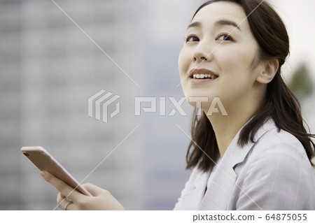 Female business outdoor smartphone smile Female business outdoor smartphone smile 64875055