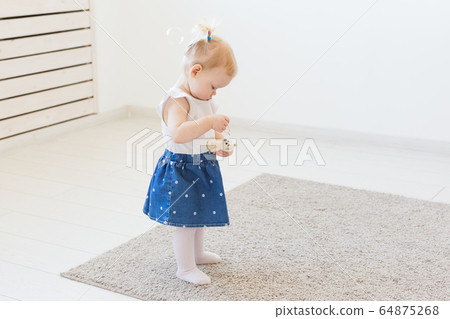 Cute baby girl playing indoors. Childhood, infant and children concept. Cute baby girl playing indoors. Childhood, infant and children concept. 64875268
