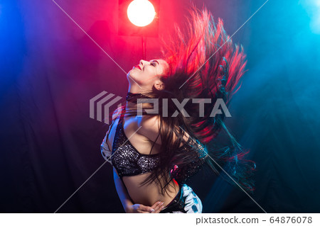 Belly dancer. Young attractive woman dancing tribal fusion on the stage. Oriental exotic dance. Belly dancer. Young attractive woman dancing tribal fusion on the stage. Oriental exotic dance. 64876078