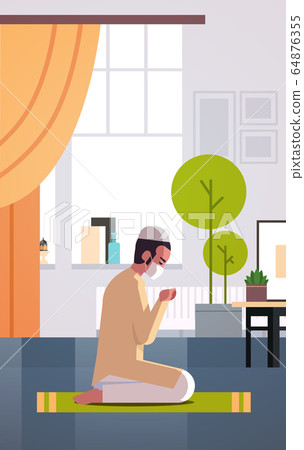 muslim man in mask praying ramadan kareem holy month religion coronavirus pandemic quarantine muslim man in mask praying ramadan kareem holy month religion coronavirus pandemic quarantine 64876355
