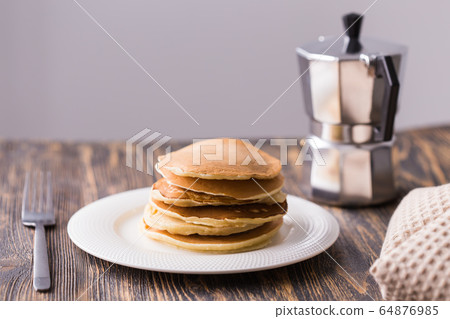 Homemade delicious pancakes on white plate. Breakfast concept Homemade delicious pancakes on white plate. Breakfast concept 64876985