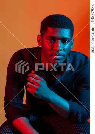 Dark neon portrait of young man wearing in shirt. Red and blue light. Technology Dark neon portrait of young man wearing in shirt. Red and blue light. Technology 64877928