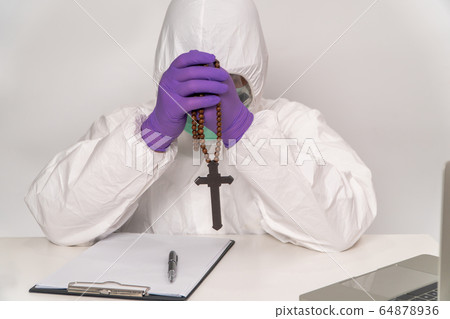Doctors in protective suits and masks are holding Doctors in protective suits and masks are holding 64878936