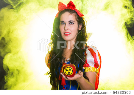 Woman holding hazardous radioactive apple. Nuclear and radiation measurement concept. Woman holding hazardous radioactive apple. Nuclear and radiation measurement concept. 64880503