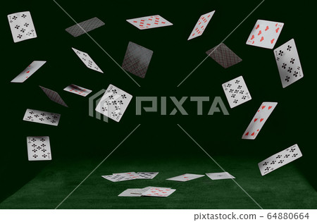 playing cards fall on a green table playing cards fall on a green table 64880664