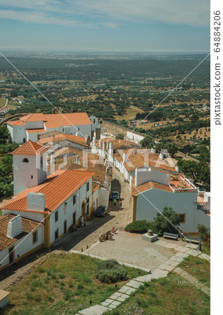 Village main street with green hills at Evoramonte 64884206