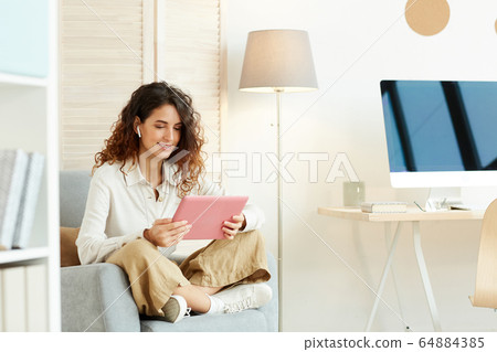 Young Woman Doing Freelance Work 64884385