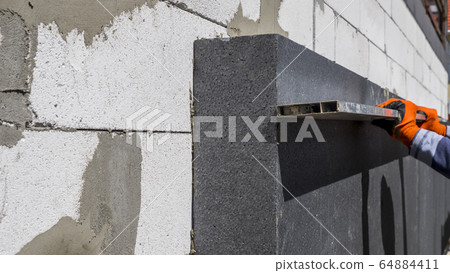 Worker checks the accuracy of the insulation sticker Worker checks the accuracy of the insulation sticker 64884411