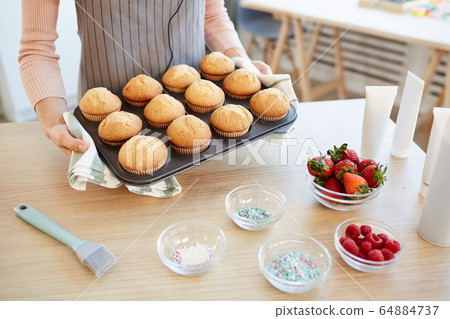 Woman With Hot Cupcakes 64884737