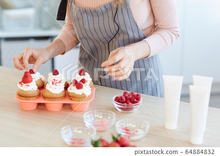 Decorating Cupcakes With Berries 64884832