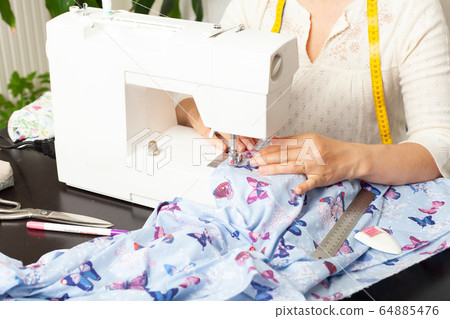 Dressmaker at work, building patterns, hands, modeling, measuring, fashion sewing machine material clothing textile Dressmaker at work, building patterns, hands, modeling, measuring, fashion sewing machine material clothing textile 64885476