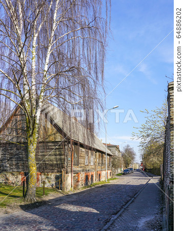 cobbled city street, old wooden house, birch near 64886202