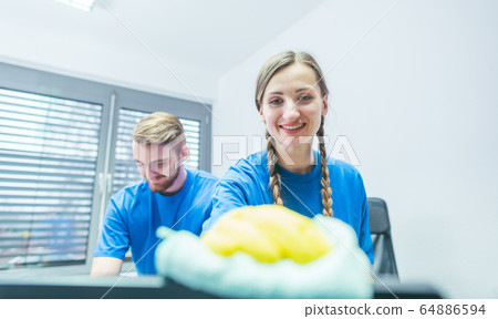 Man and woman team of commercial cleaners working 64886594
