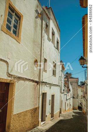 Alley with old colorful houses in Elvas Alley with old colorful houses in Elvas 64886662