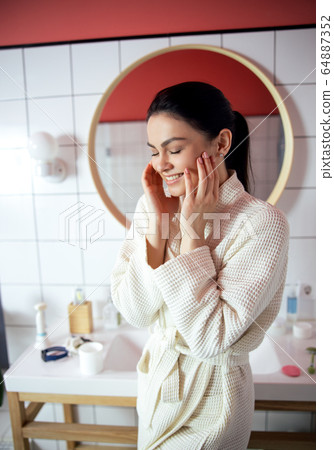 Cheerful woman looking after her beauty stock photo 64887352