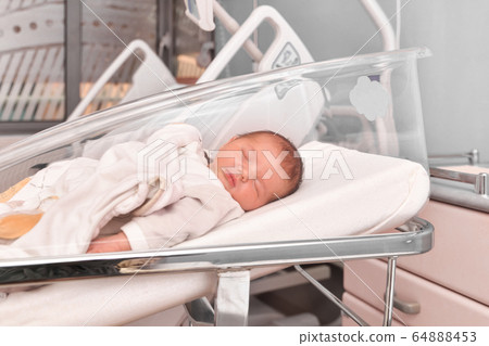 Newborn baby sleeping in the hospital bed Newborn baby sleeping in the hospital bed 64888453
