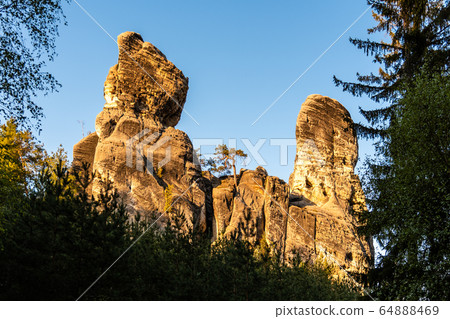 Monumental sandstone rock formation in the miidle of spring forest of Bohemian Paradise, Czech: Cesky raj, Czech Republic Monumental sandstone rock formation in the miidle of spring forest of Bohemian Paradise, Czech: Cesky raj, Czech Republic 64888469