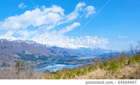Lake Aoki and Gotateyama Mountain Range seen from Omachi City, Gongen Mountain (April) Lake Aoki and Gotateyama Mountain Range seen from Omachi City, Gongen Mountain (April) 64889407