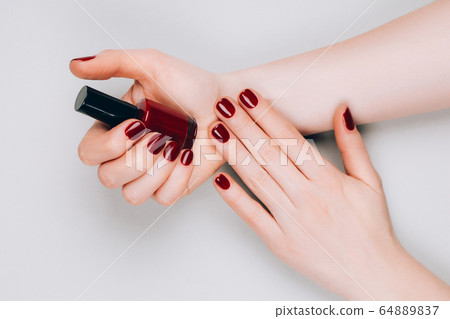 Manicure and bottle of nail polish Manicure and bottle of nail polish 64889837