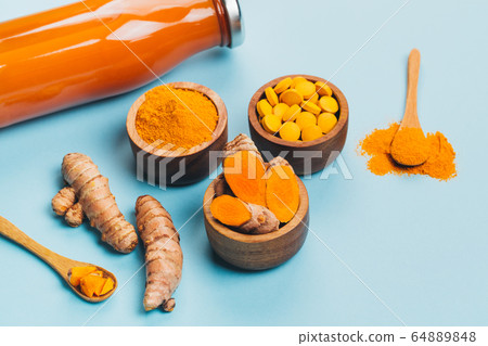 Turmeric in different conditions: fresh, dry root, pills, powder and cut plant. Turmeric in different conditions: fresh, dry root, pills, powder and cut plant. 64889848