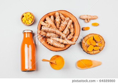 Turmeric in different conditions: fresh, dry root, pills, powder and cut plant. Turmeric in different conditions: fresh, dry root, pills, powder and cut plant. 64889860