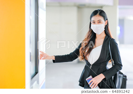 Beautiful business woman with hygiene mask point to sky train or transportation map 64891242