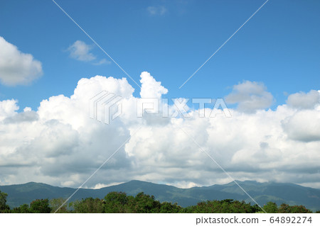 Mountains green grass and blue sky landscape Mountains green grass and blue sky landscape 64892274