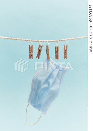Medical protective mask hanging on a rope 64893325