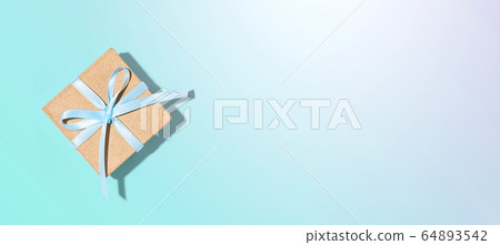 Gift box with blue ribbon overhead view 64893542