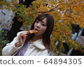 Beautiful Osaka woman eating model photo: Mitarashi Dango 64894305
