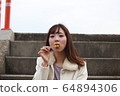 Beautiful Osaka woman eating model photo: Mitarashi Dango 64894306