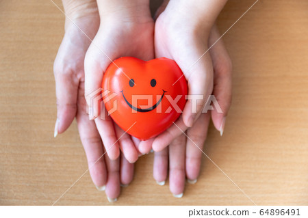 mother and daughter hands holding red heart, mother and daughter hands holding red heart, 64896491