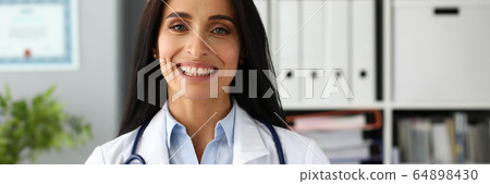 Beautiful smiling GP holding in hands red toy heart 64898430