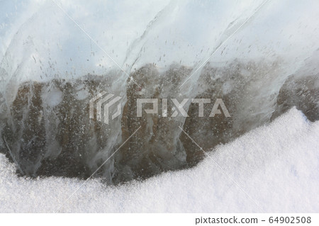 Cracks on the surface of the river in winter Cracks on the surface of the river in winter 64902508