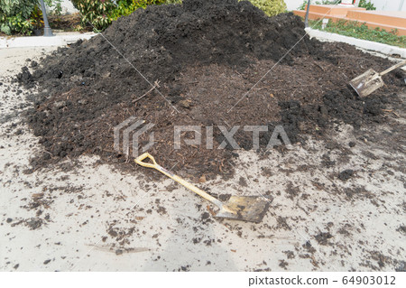 A hoe and soil fertile ground surface. Close up of 64903012