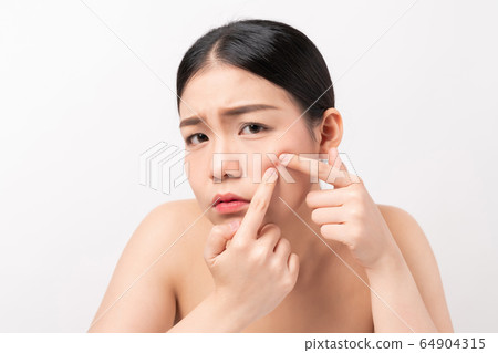 Asian woman squeezing pimples on her face, skin care lifestyle concept. Asian woman squeezing pimples on her face, skin care lifestyle concept. 64904315
