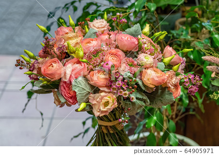 Close-up of beautiful multi-colored bouquet of mixed roses in flower shop. Fresh cut flowers Close-up of beautiful multi-colored bouquet of mixed roses in flower shop. Fresh cut flowers 64905971